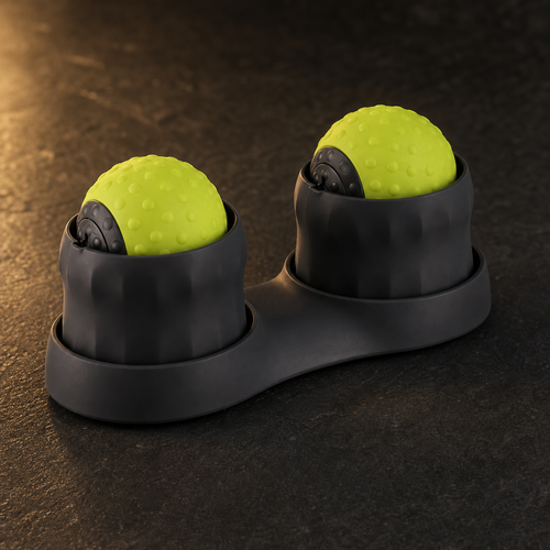 AuraZen TheraSphere double massage-ball device in charcoal and green on a dark studio surface.