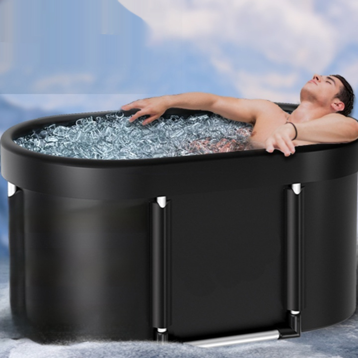 Person seated in the elongated oval AuraZen FrostFold during a cold-water routine.