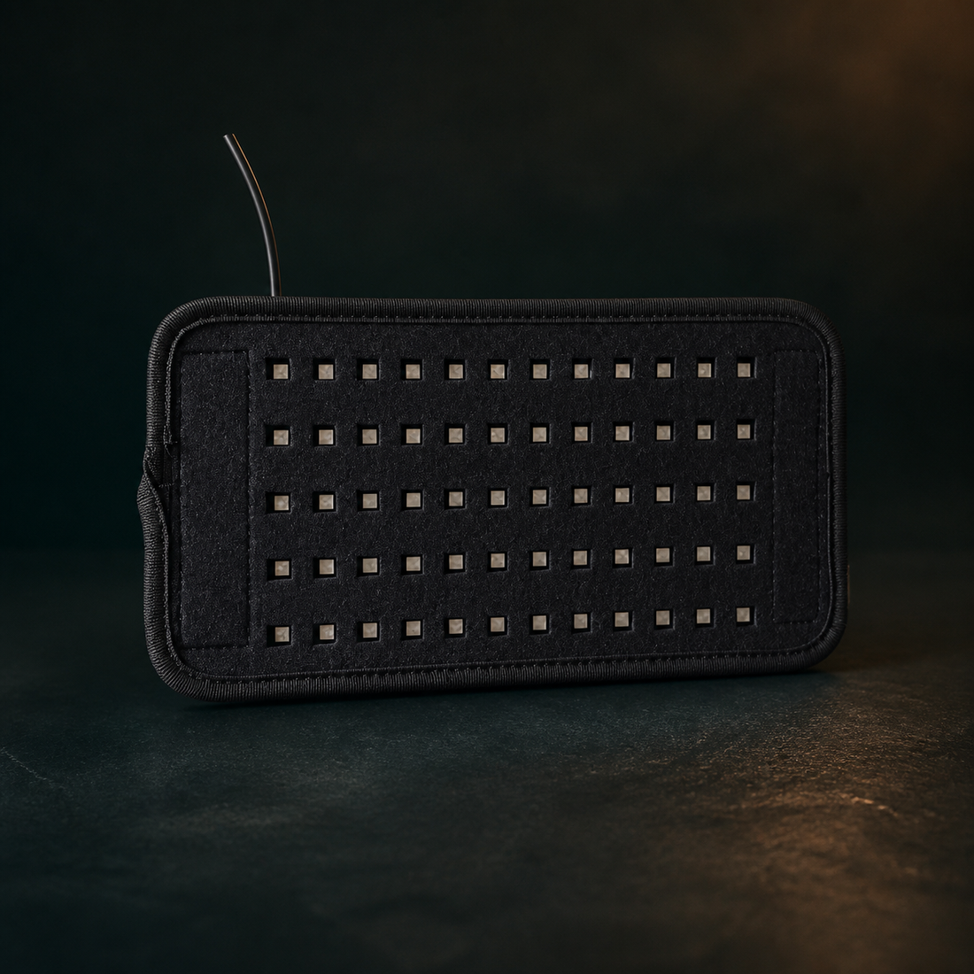 AuraZen LumaBelt wrap and removable light panel switched off on a dark premium surface.